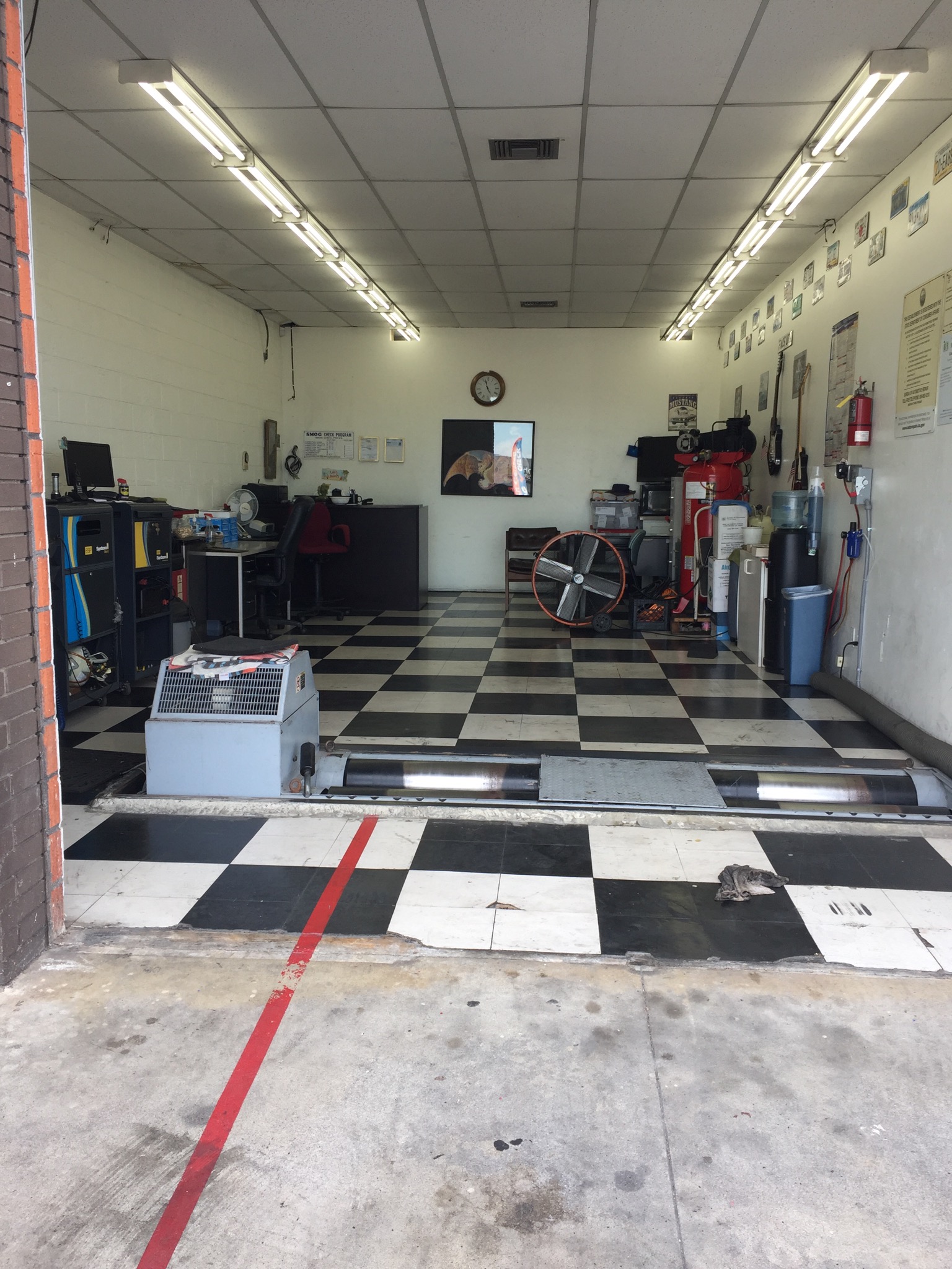 Interior of 7 Stars Test Only smog check station garage with checkered floor